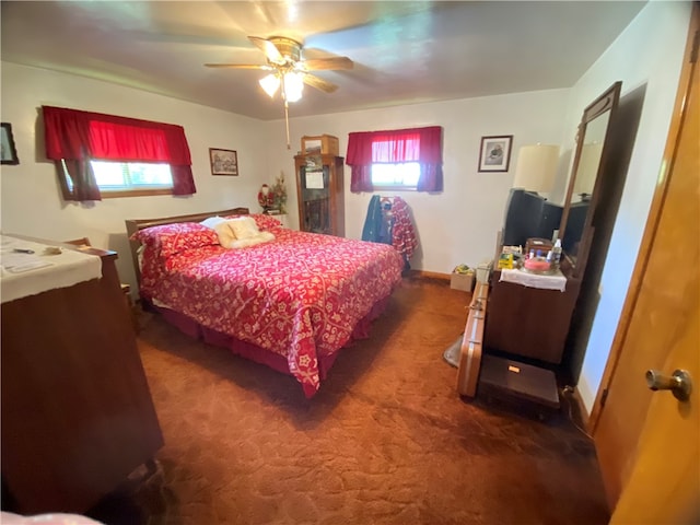 bedroom with ceiling fan and dark carpet