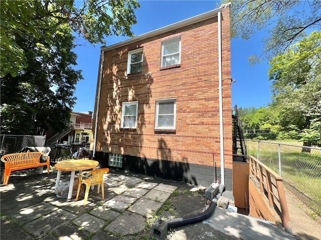 rear view of property featuring a patio