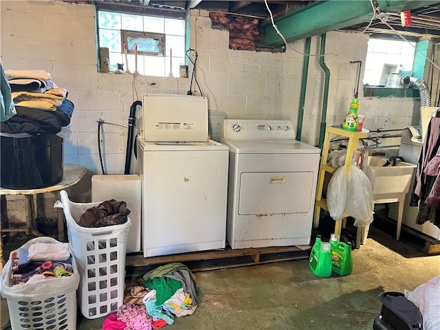 clothes washing area with washing machine and dryer