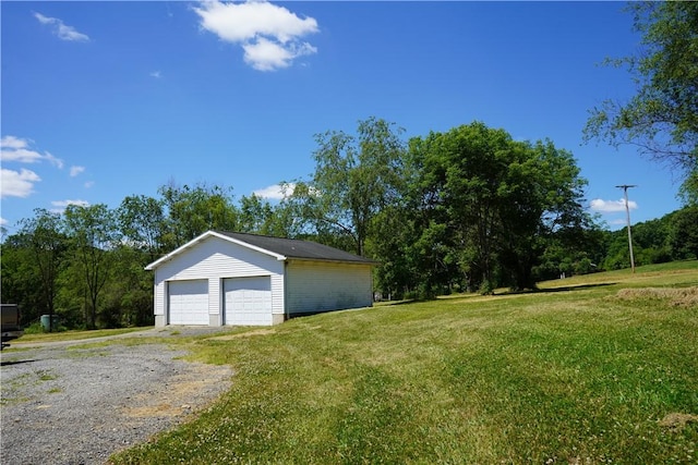 garage featuring a lawn