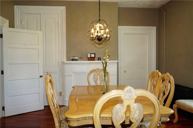 dining room featuring an inviting chandelier and dark wood-type flooring