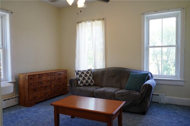 living room featuring a baseboard radiator, dark carpet, plenty of natural light, and ceiling fan