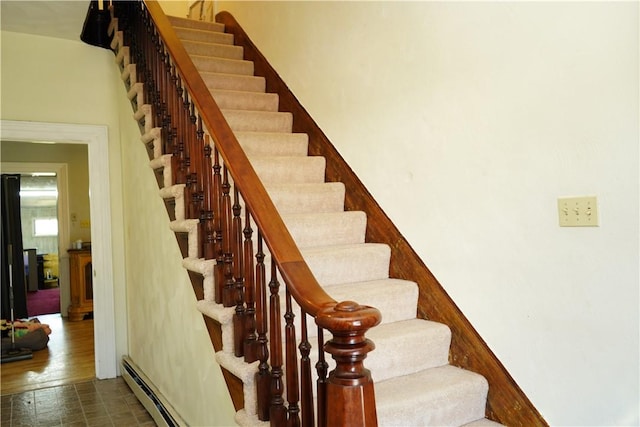 stairs featuring a baseboard radiator