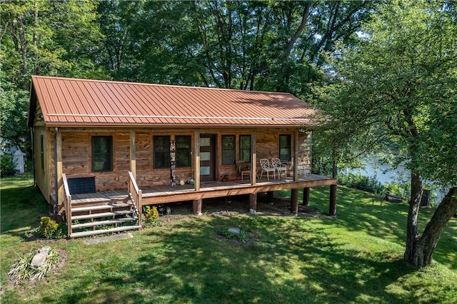 back of property with a lawn and a porch