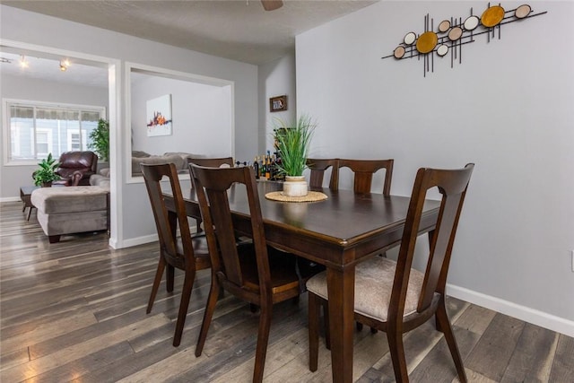 dining space featuring ceiling fan and dark hardwood / wood-style floors