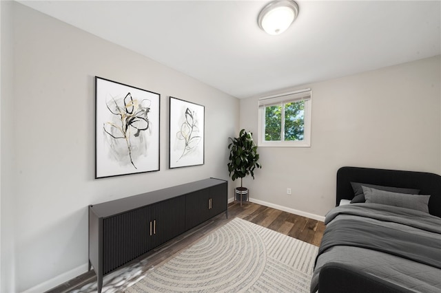 bedroom with dark hardwood / wood-style flooring