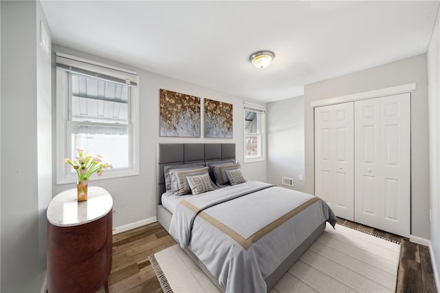 bedroom with hardwood / wood-style flooring and a closet