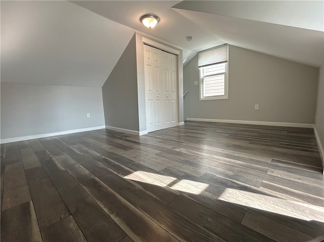 bonus room featuring lofted ceiling and dark hardwood / wood-style flooring