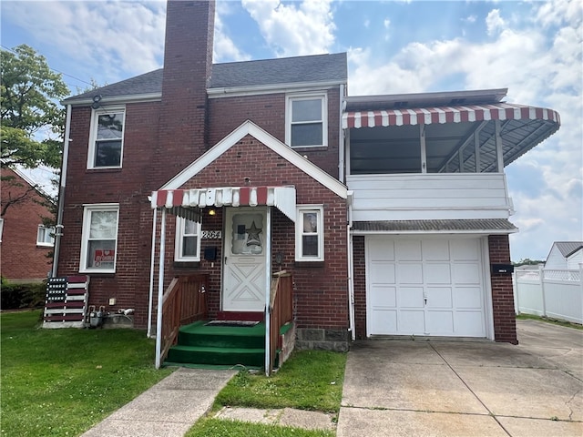 view of front facade with a garage and a front lawn