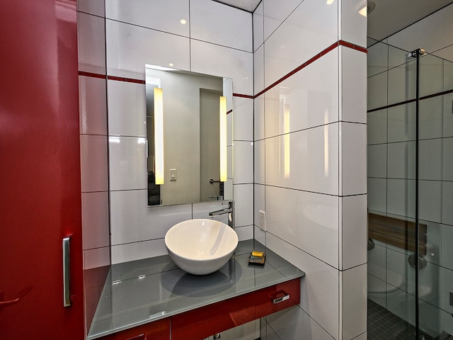 bathroom with a shower with door and large vanity