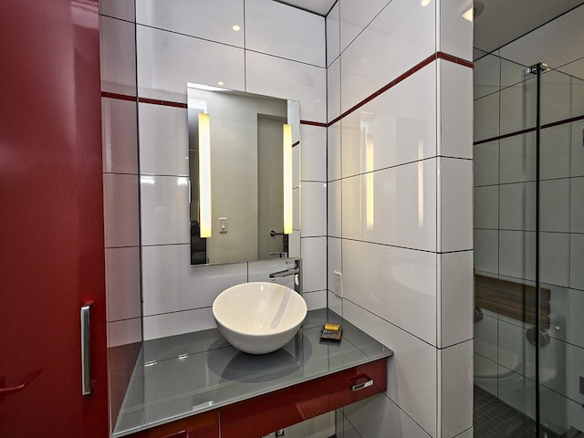 bathroom featuring vanity, tasteful backsplash, a stall shower, and tile walls