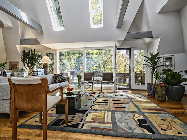 living area featuring wood finished floors and a skylight