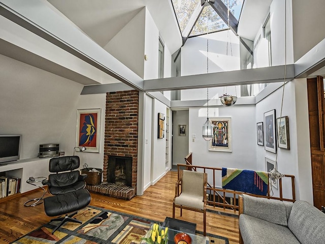 living room with wood finished floors and a towering ceiling