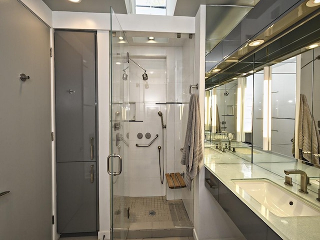 full bath with double vanity, a sink, and a stall shower