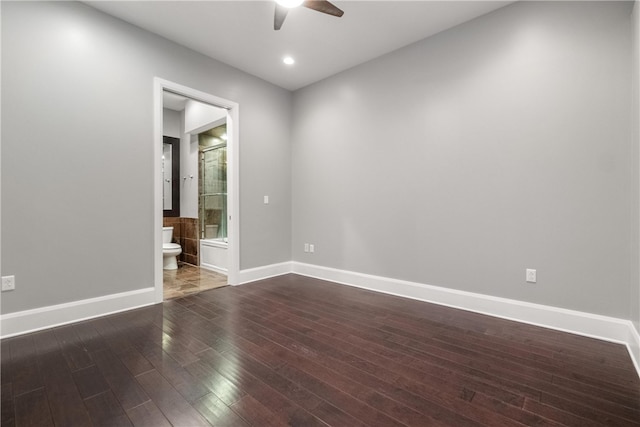 spare room featuring dark wood-type flooring and ceiling fan