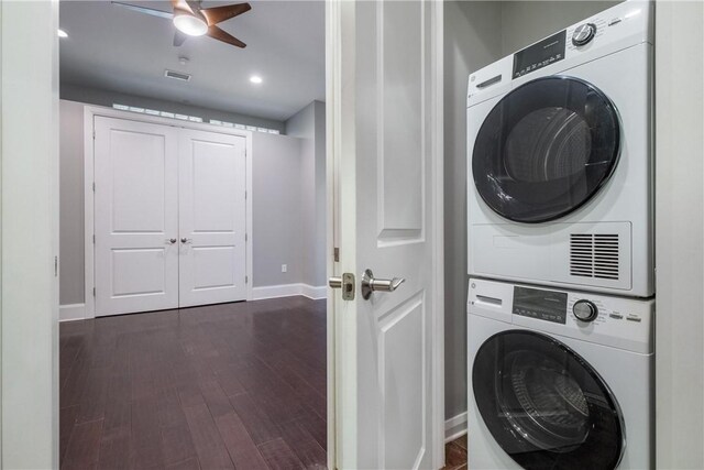 laundry area featuring stacked washing maching and dryer, ceiling fan, and hardwood / wood-style floors