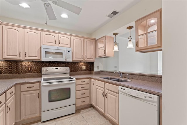 kitchen featuring light brown cabinetry, sink, hanging light fixtures, white appliances, and backsplash