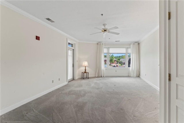 carpeted spare room featuring crown molding and ceiling fan