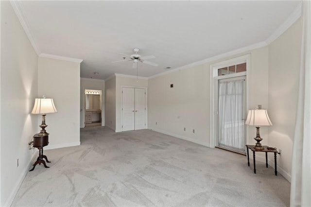 carpeted spare room with ornamental molding and ceiling fan