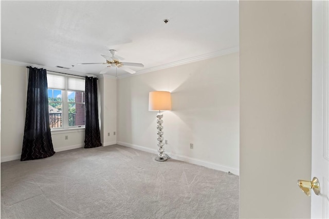 carpeted spare room with crown molding and ceiling fan