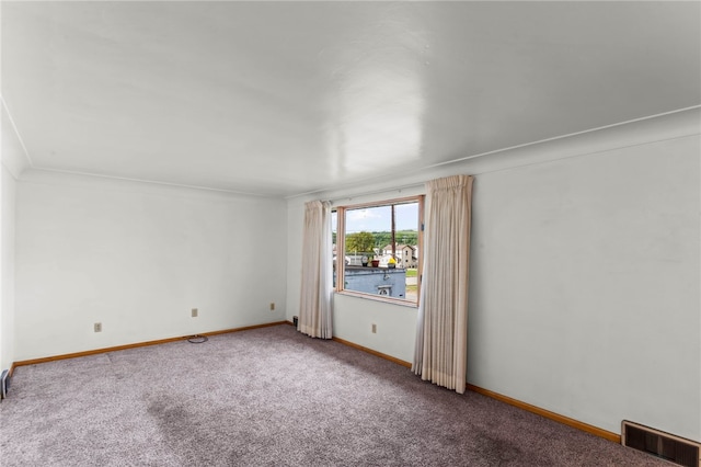 spare room featuring crown molding and carpet flooring