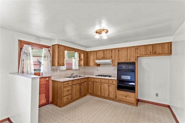 kitchen with black double oven, light tile flooring, gas cooktop, tasteful backsplash, and sink