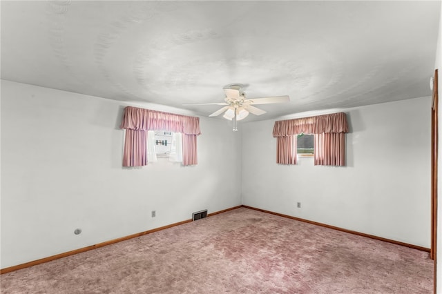 carpeted empty room featuring plenty of natural light and ceiling fan