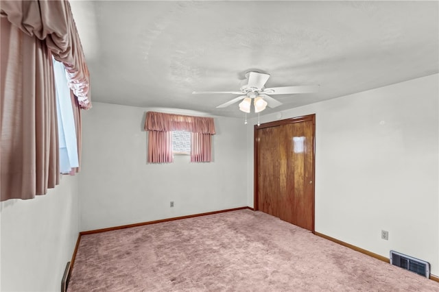 unfurnished bedroom featuring carpet flooring and ceiling fan