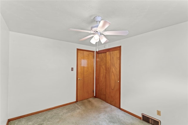 unfurnished bedroom featuring a closet, carpet floors, and ceiling fan