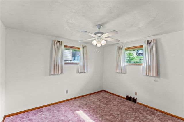 carpeted empty room featuring ceiling fan