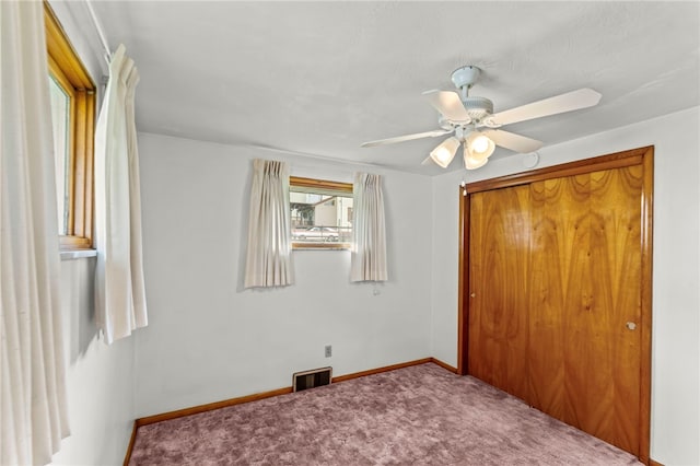 unfurnished bedroom featuring a closet, ceiling fan, and carpet floors