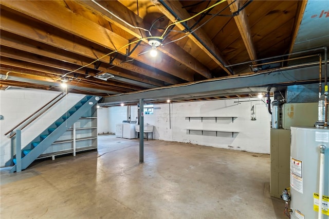 basement featuring washer / clothes dryer, sink, and gas water heater