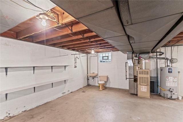 basement with water heater, sink, and heating utilities