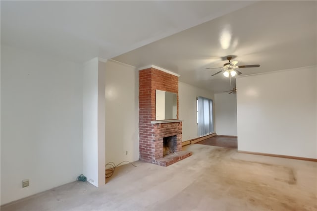 unfurnished living room featuring crown molding, a fireplace, carpet floors, and ceiling fan