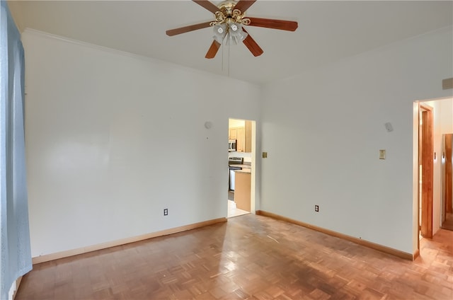 empty room with ornamental molding, light parquet flooring, and ceiling fan