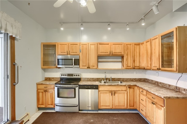 kitchen featuring appliances with stainless steel finishes, sink, rail lighting, ceiling fan, and light brown cabinets