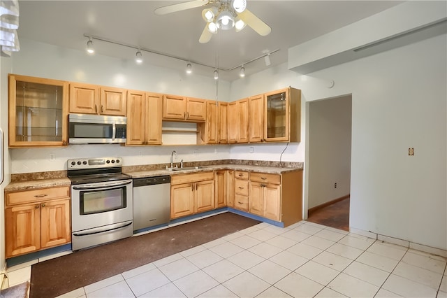 kitchen featuring light brown cabinetry, appliances with stainless steel finishes, sink, and light tile patterned floors