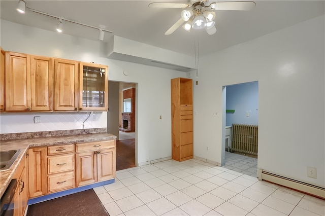 kitchen featuring radiator heating unit, a baseboard radiator, light tile patterned floors, ceiling fan, and dishwasher