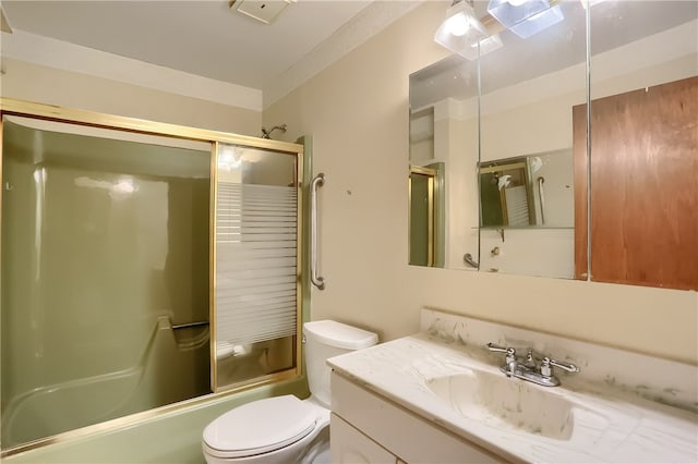 full bathroom with vanity, toilet, and shower / bath combination with glass door