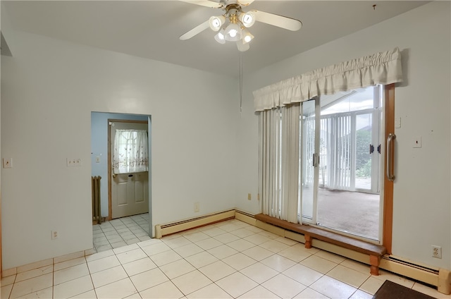 tiled spare room featuring a wealth of natural light, a baseboard heating unit, and ceiling fan