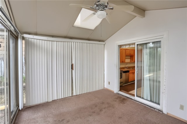 carpeted empty room with lofted ceiling with beams, sink, and ceiling fan