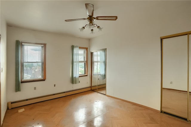 unfurnished bedroom with ceiling fan, baseboard heating, and light parquet floors