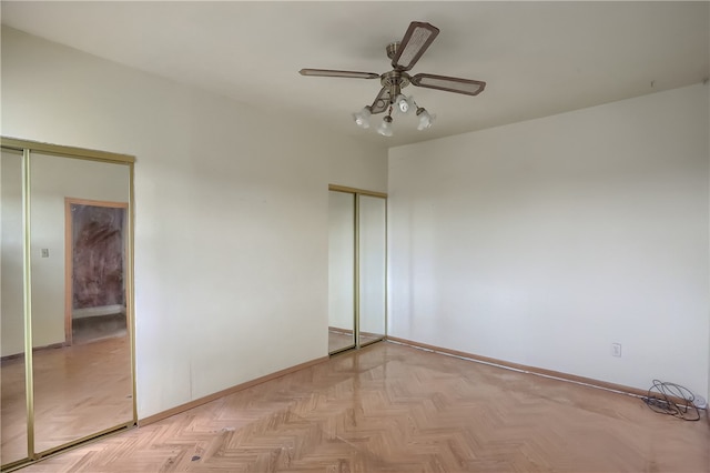 unfurnished bedroom with light parquet floors and ceiling fan