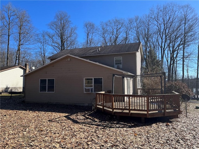 rear view of property featuring a wooden deck