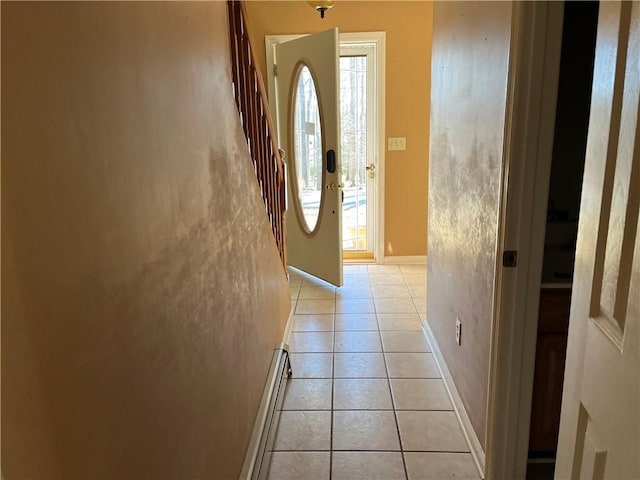 tiled foyer entrance featuring a baseboard heating unit