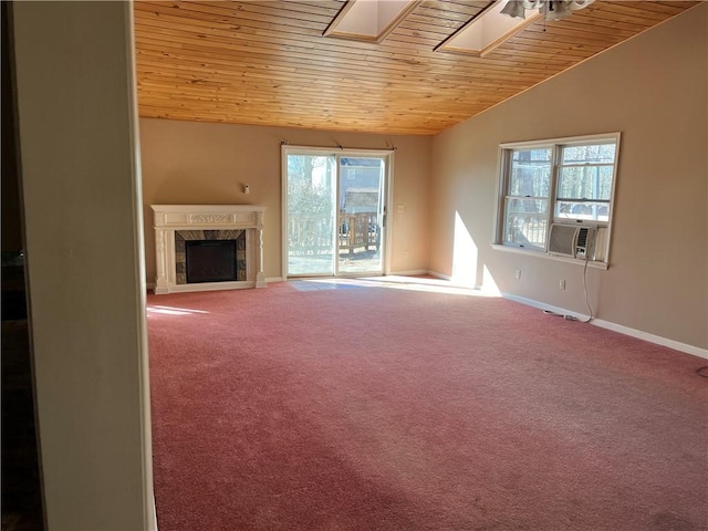 unfurnished living room featuring carpet, wooden ceiling, cooling unit, vaulted ceiling with skylight, and a fireplace