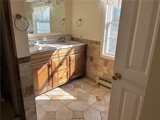 bathroom with vanity, tile walls, and a baseboard heating unit