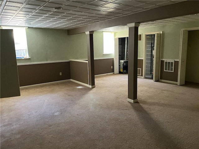 basement with light carpet and plenty of natural light