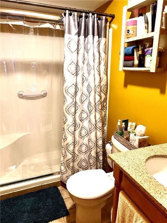 bathroom with tile patterned floors, a shower with curtain, vanity, and toilet