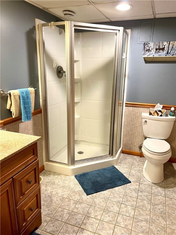 bathroom featuring vanity, an enclosed shower, and toilet